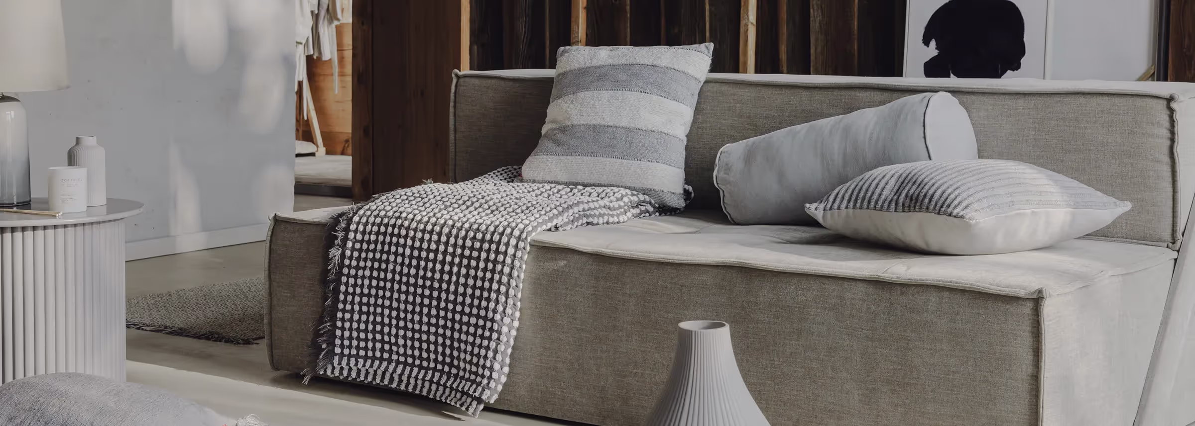 A couch with pillows and a blanket on it.